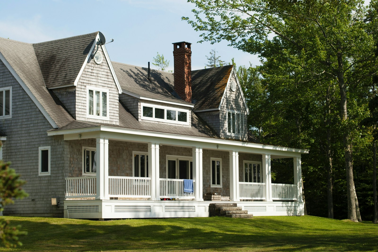 white and brown wooden house near green trees during daytime, house